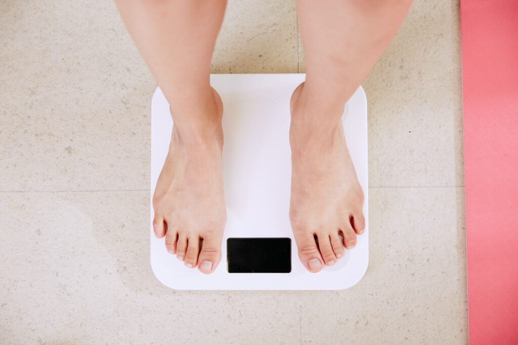 Person stood on top of a weighing machine.