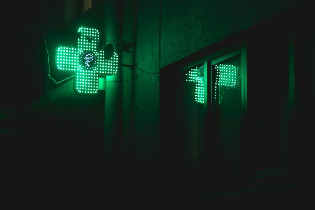 Green pharmacy light at night