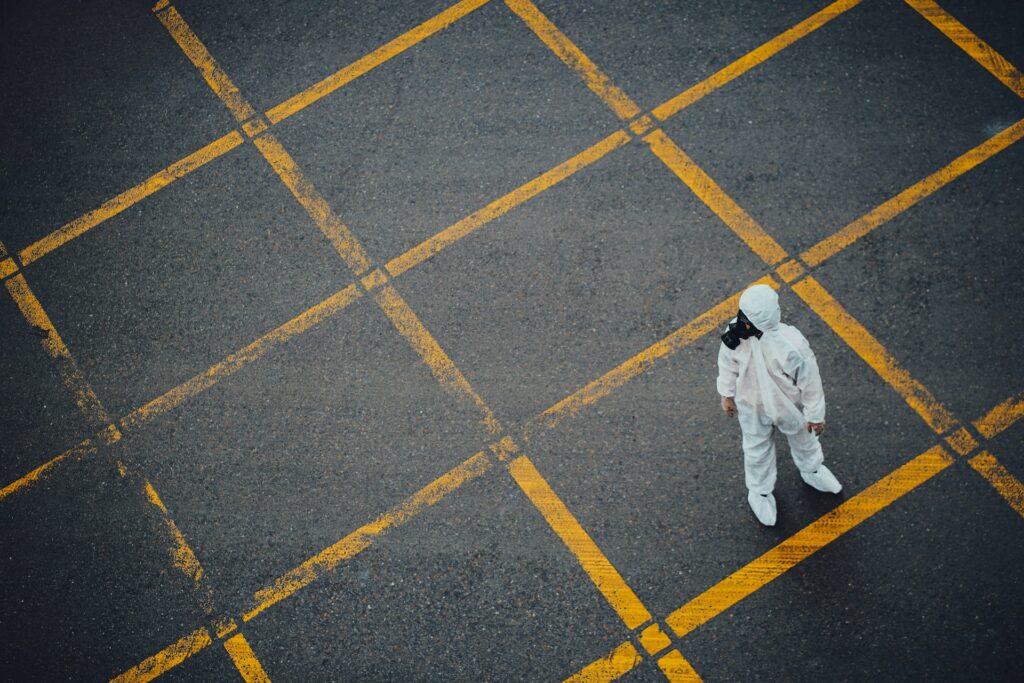 Picture of a person wearing protective clothing and a gas mask