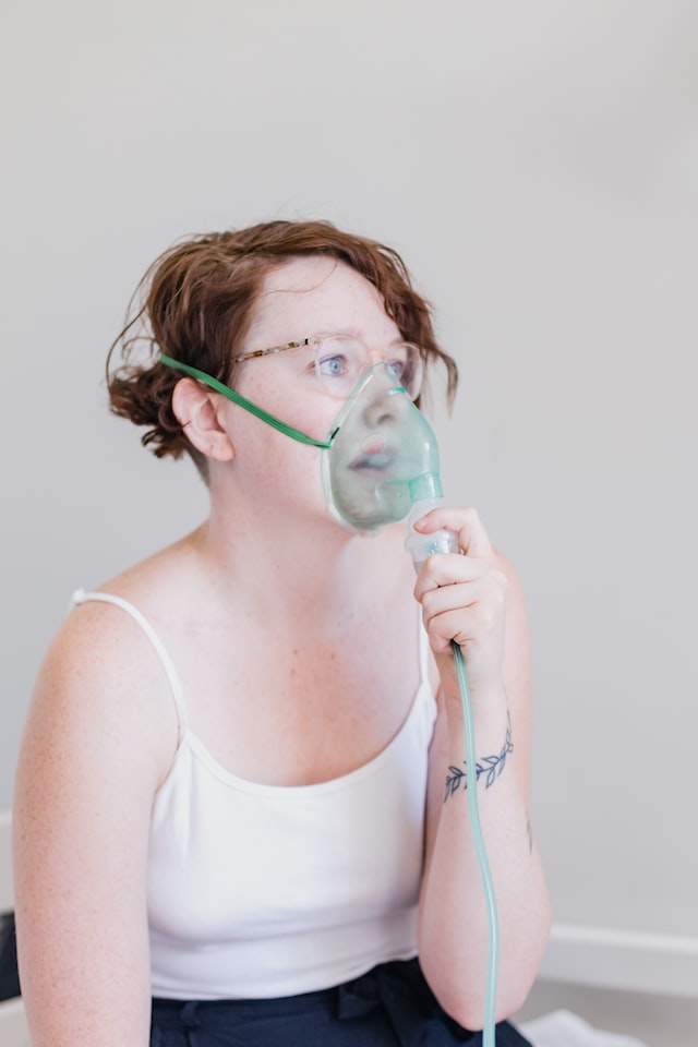 Girl using an oxygen breathing apparatus 